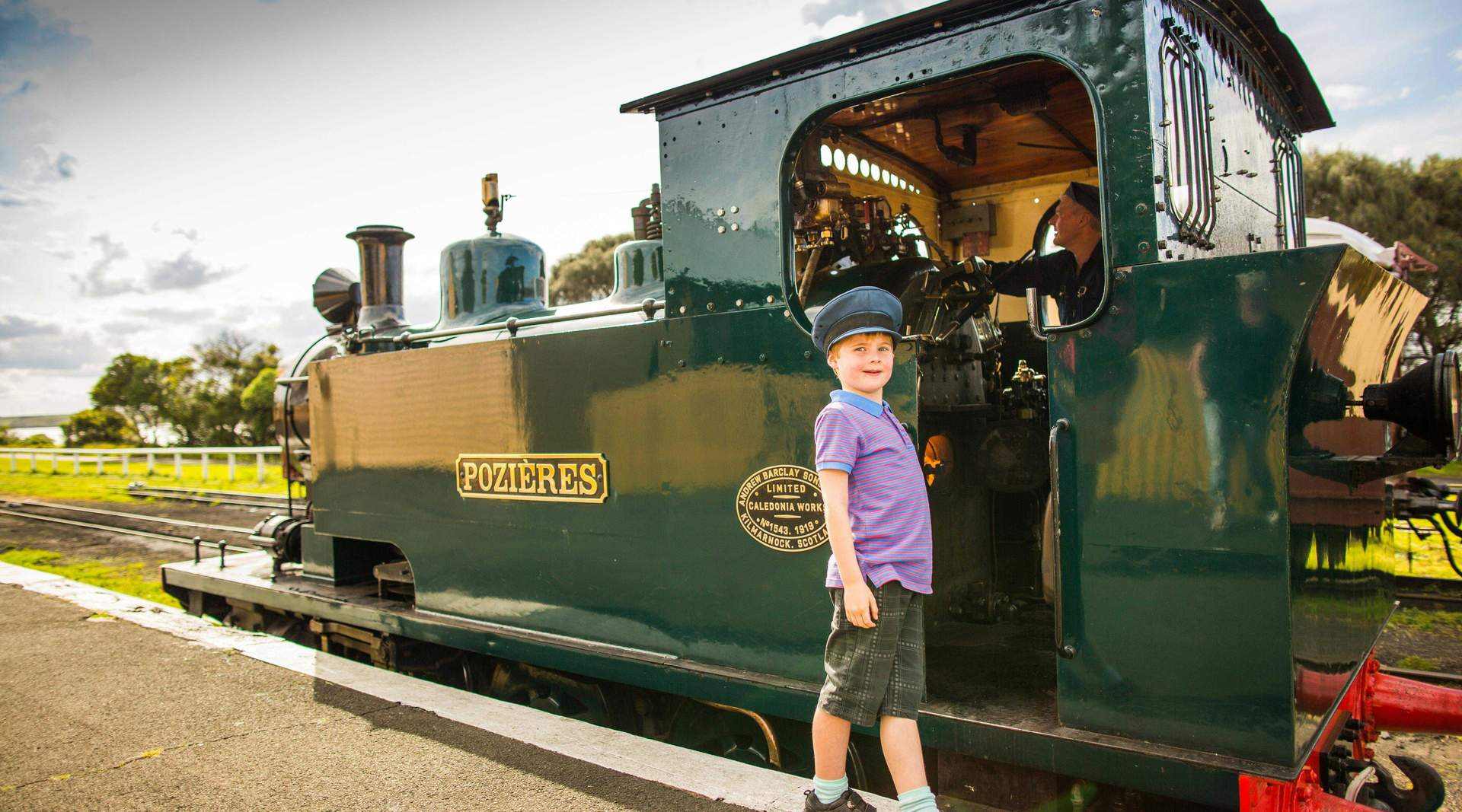 A visitor beside the Pozieres steam locomotive at The Bellarine Railway