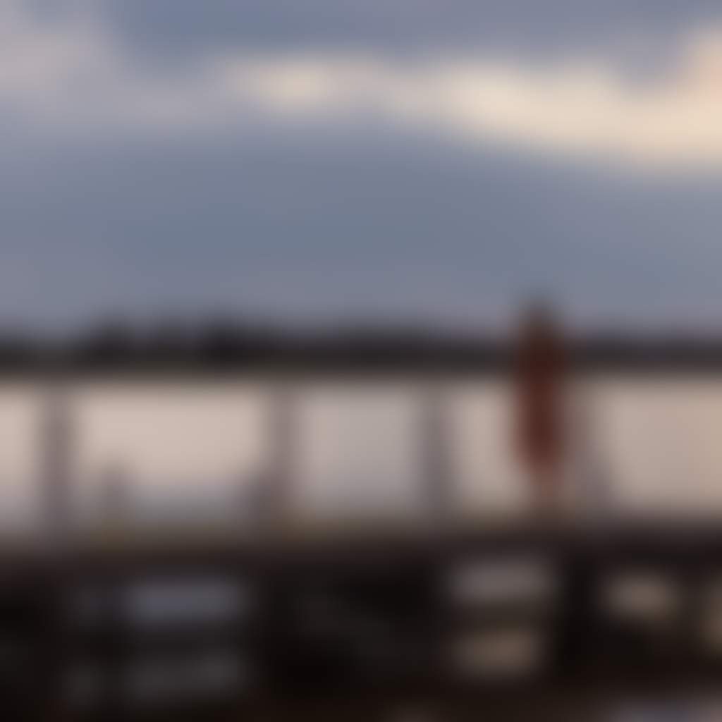 Girl standing on Paynesville jetty at sunset