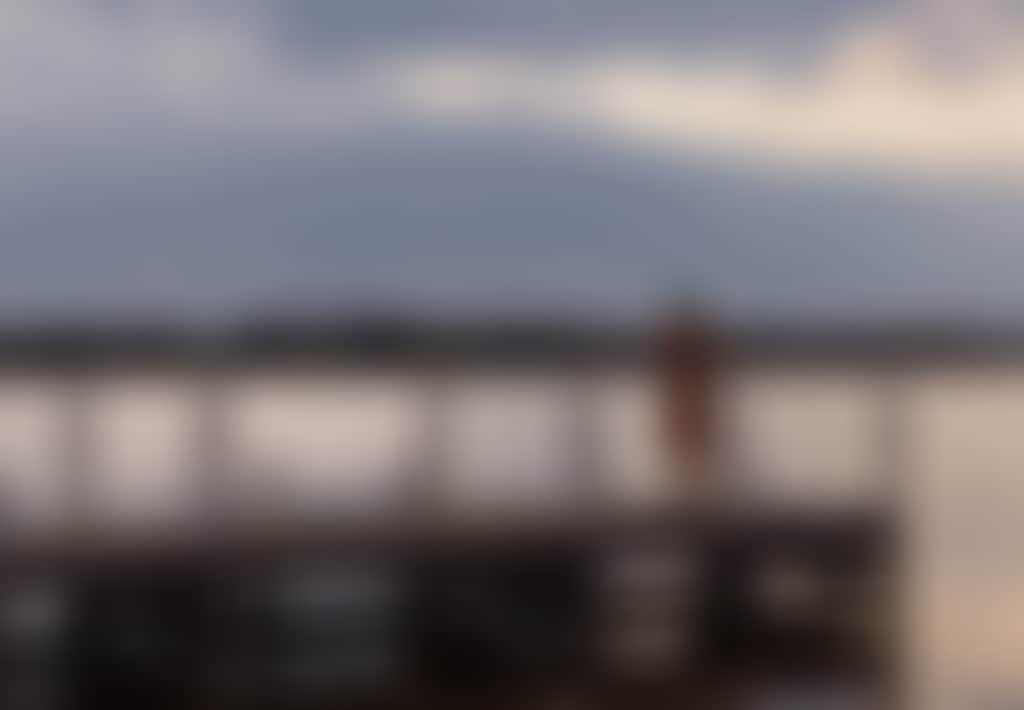 Girl standing on Paynesville jetty at sunset