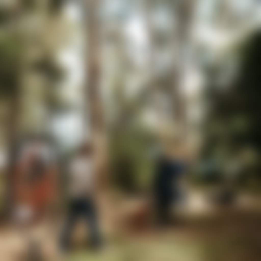 Couple and dog walking through Laurie Collins Sculpture Garden