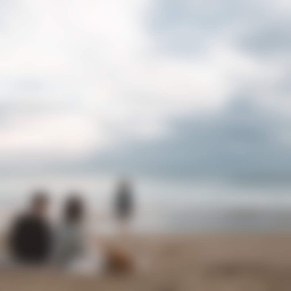 Family sitting on rug at beach at Sandy Point