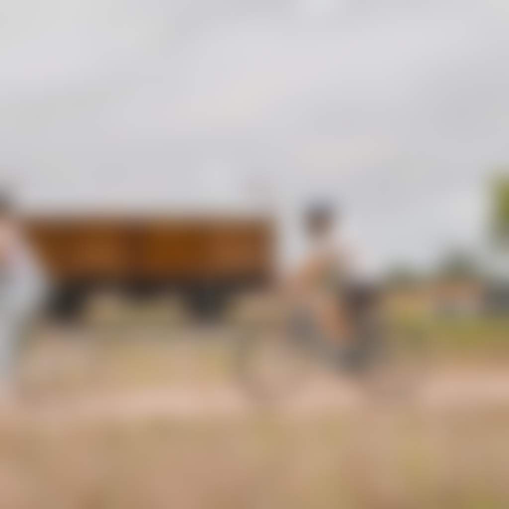 Gippsland Plains Rail Trail cyclists riding past train carriage at Cowwarr