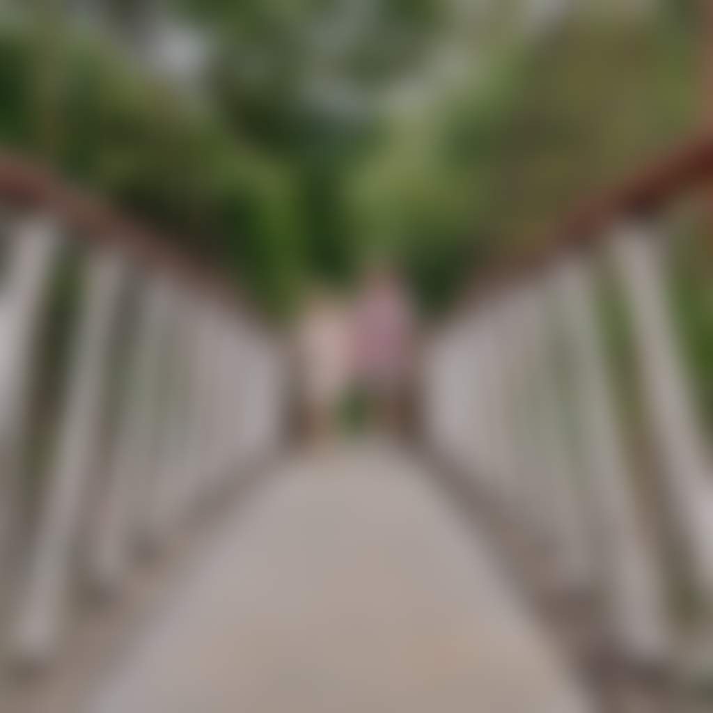 Couple walking on Buchan Swing Bridge over river