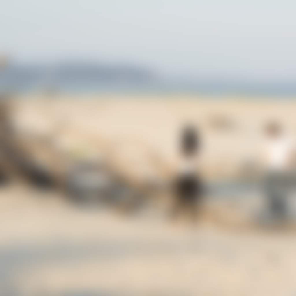 People Looking at Driftwood Teepee Hut on Inverloch Beach