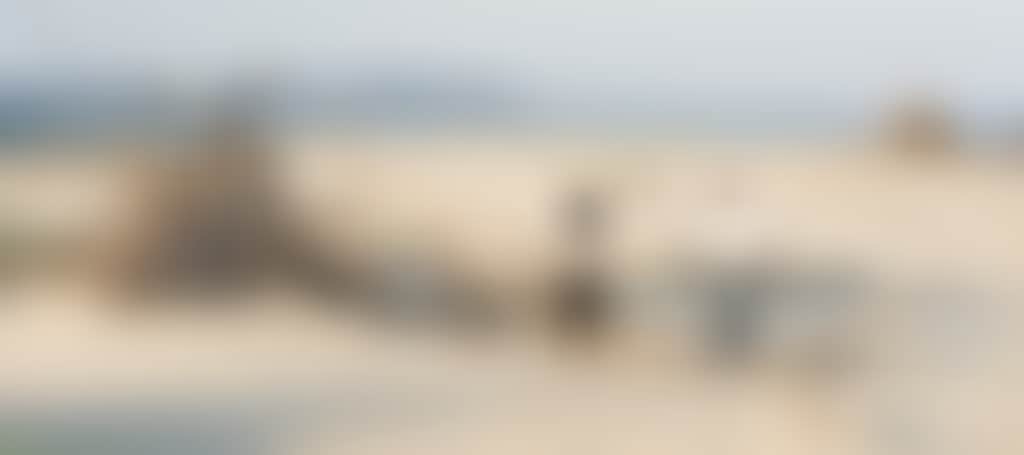 People Looking at Driftwood Teepee Hut on Inverloch Beach