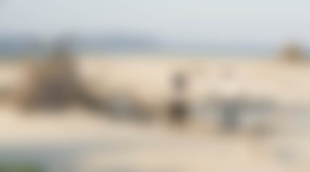 People Looking at Driftwood Teepee Hut on Inverloch Beach