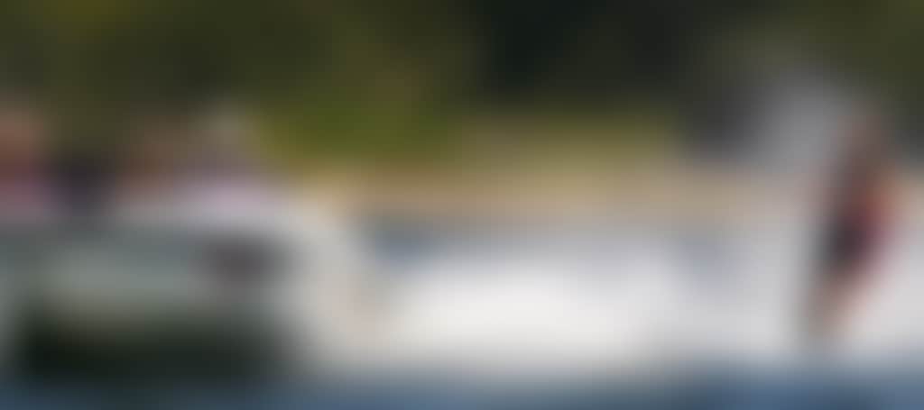Man wakeboarding behind waterski boat Heyfield Central Gippsland