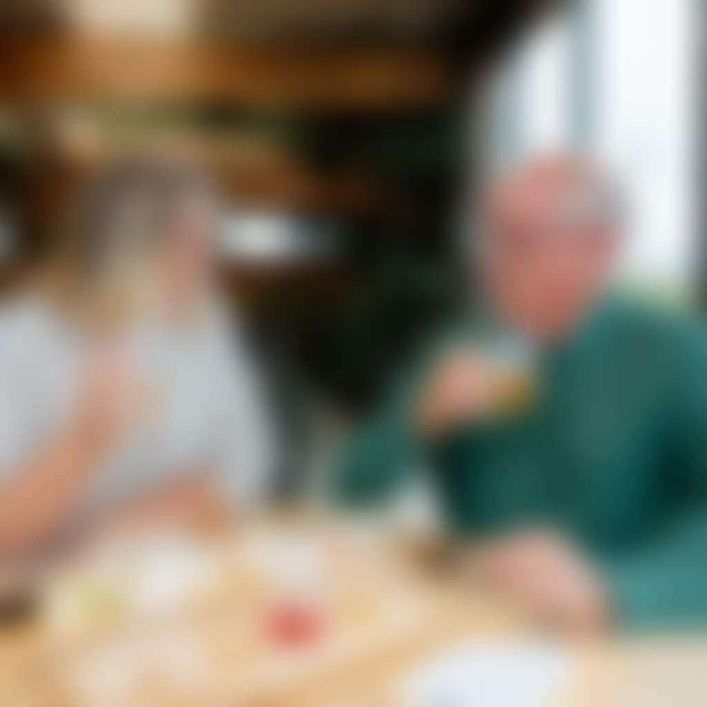 Gurneys Cider couple eating antipasto platter with tasting paddle inside