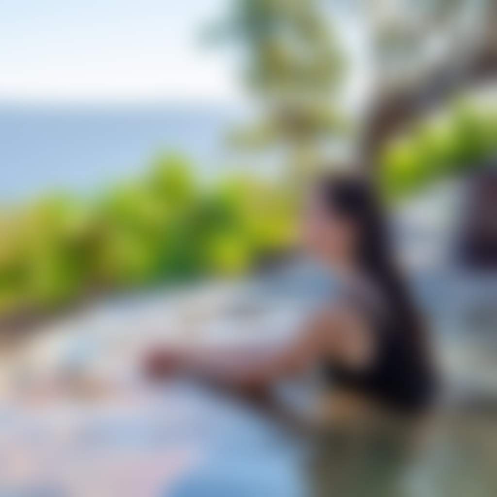 Metung Hot Springs person on hilltop bathing thermal pool overlooking lakes