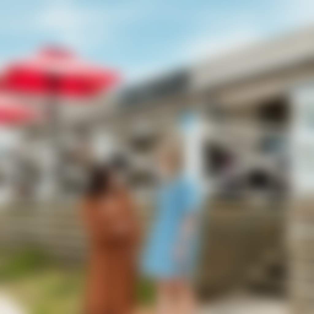 Kilcunda Ocean View Hotel couple standing out the front with deck and umbrellas