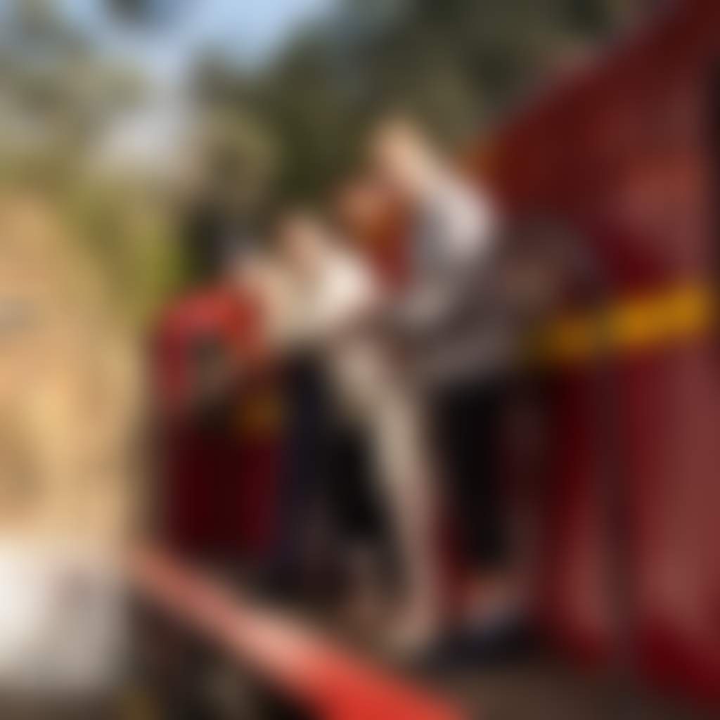 Walhalla Goldfields Railway family standing next to red locomotive at Walhalla Station