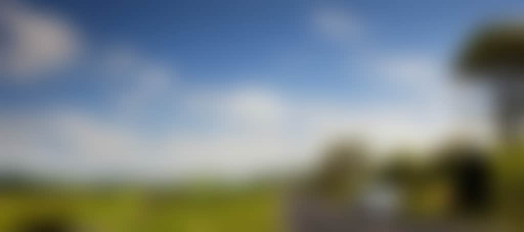 Car driving among the green rolling hills