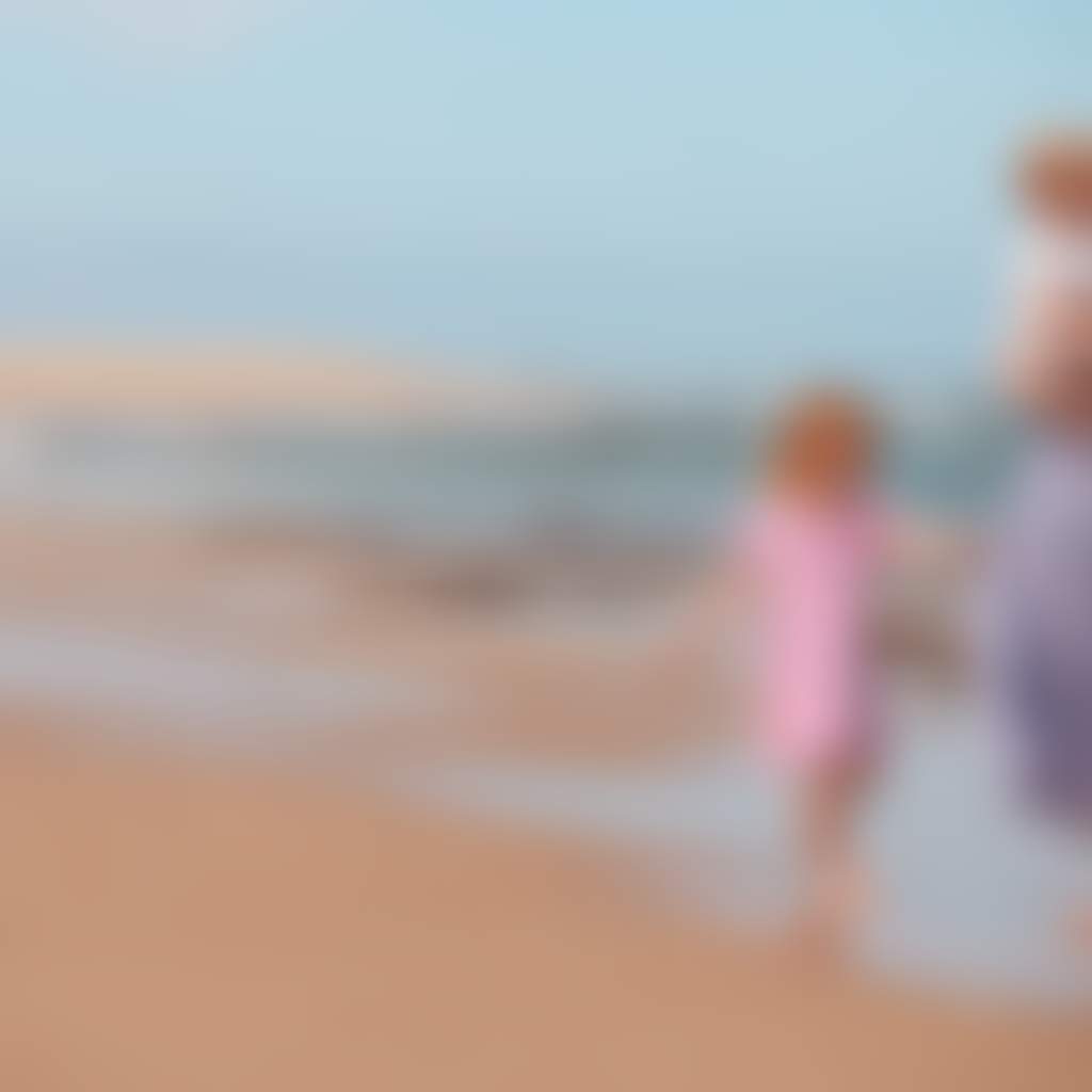 Lake Tyers Beach young family playing on sand near ocean