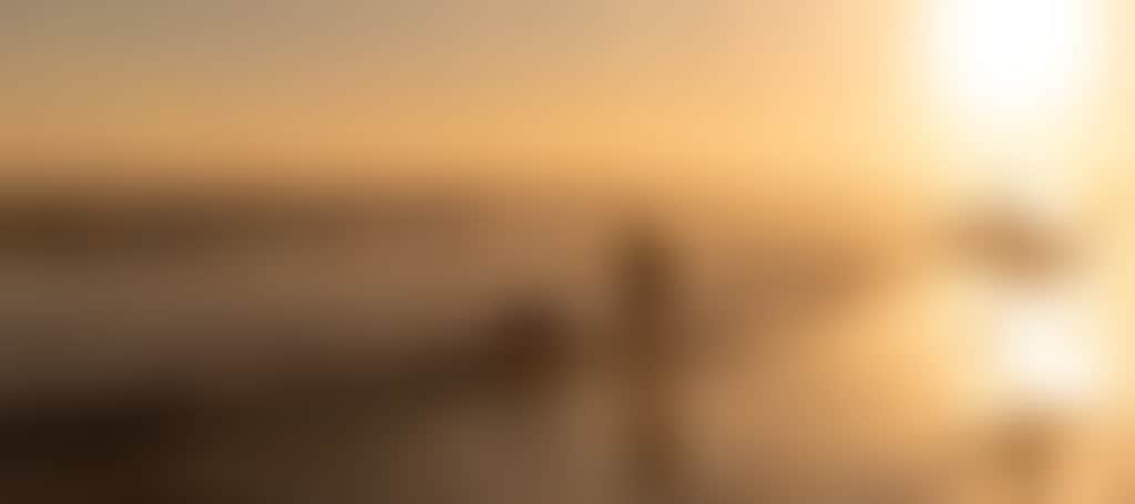 Sunset surfer and girl with dog on beach at Venus Bay South Gippsland CROP