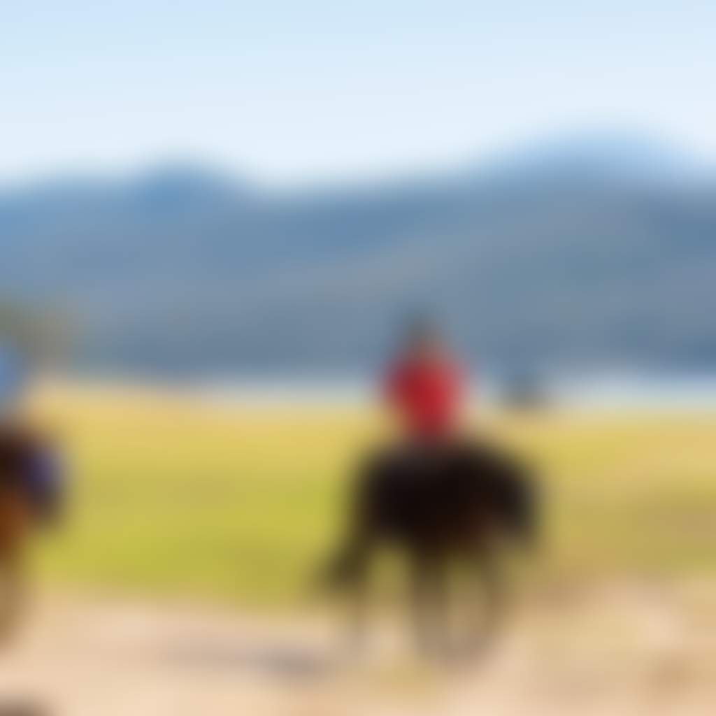 Two people horseriding at Lake Glenmaggie Central Gippsland