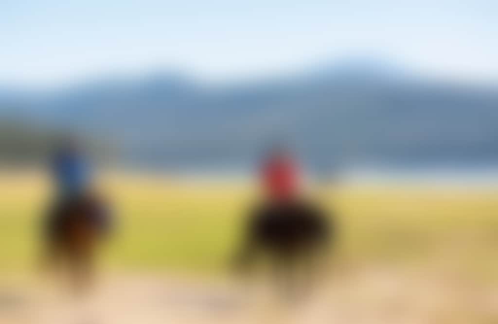 Two people horseriding at Lake Glenmaggie Central Gippsland