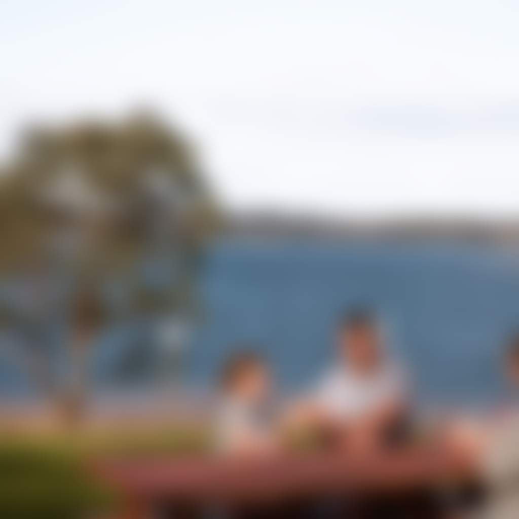 Blue Rock Lake Willow Grove family eating on picnic table on lakes edge