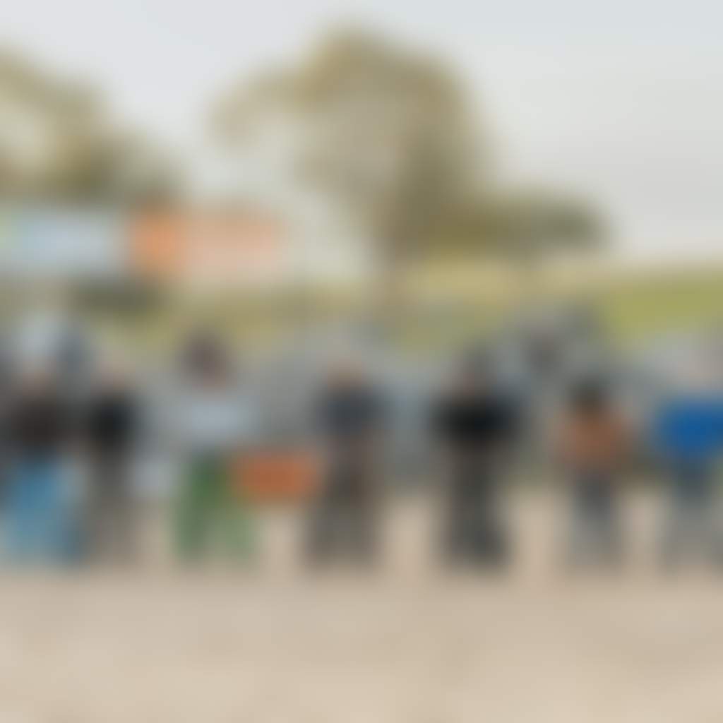 Farm World people wearing chaps on the sand at Rodeo event Lardner Park