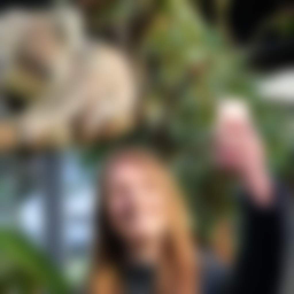 Woman taking selfie with koala at Gumbuya World West Gippsland