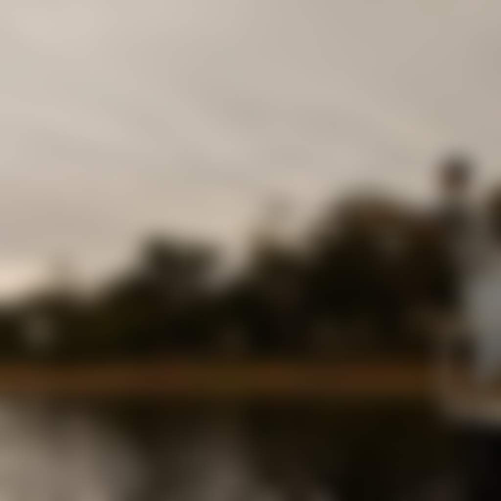 Lake Tyers person fishing from jetty in lake next to beach