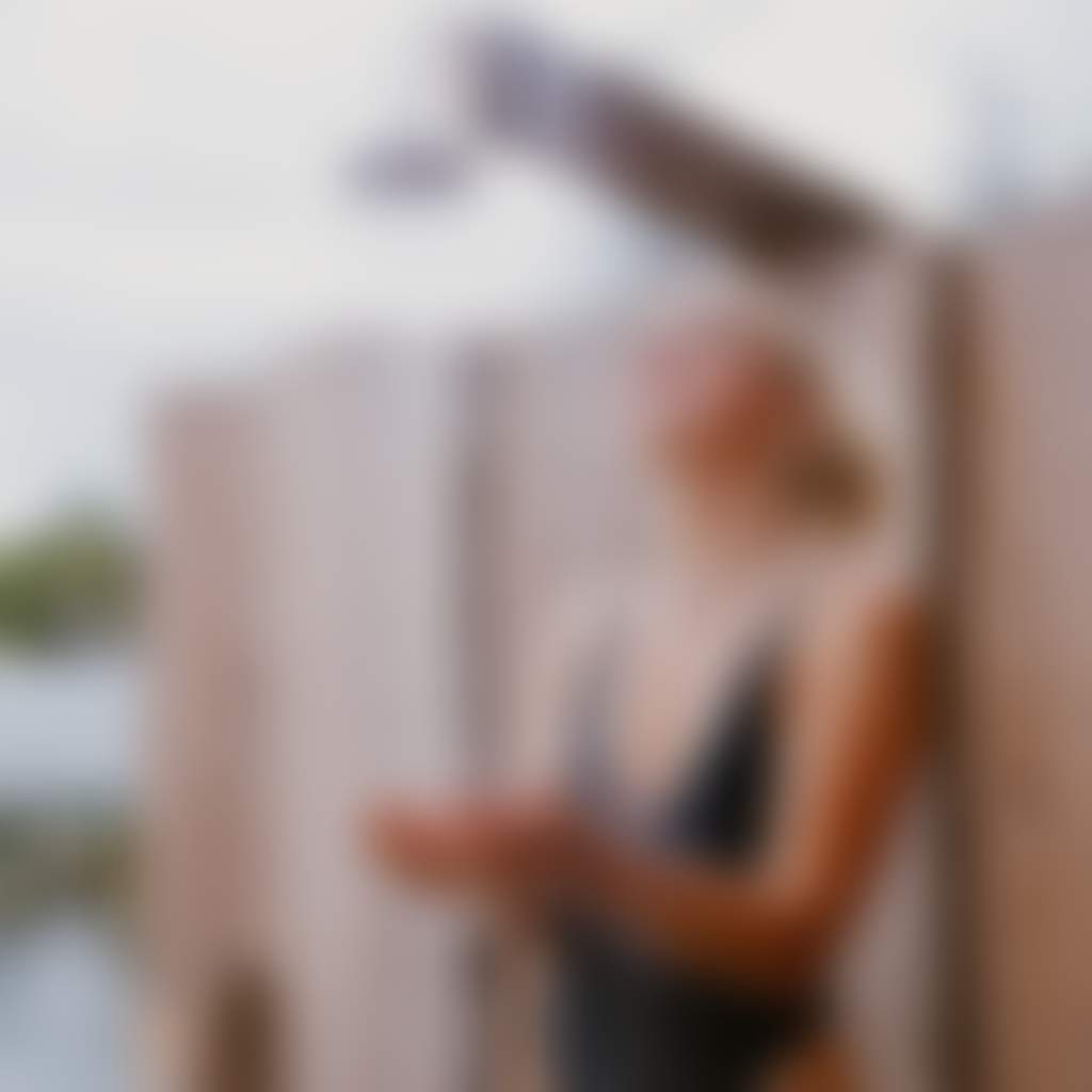 Woman using outdoor Geothermal Shower at Metung Hot Springs