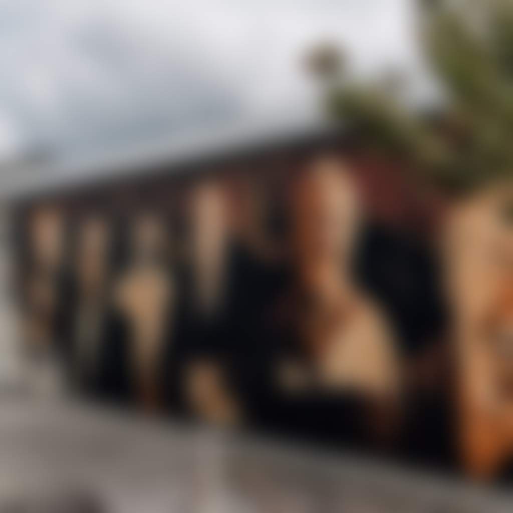 Heesco Town couple walking past mural of mens faces