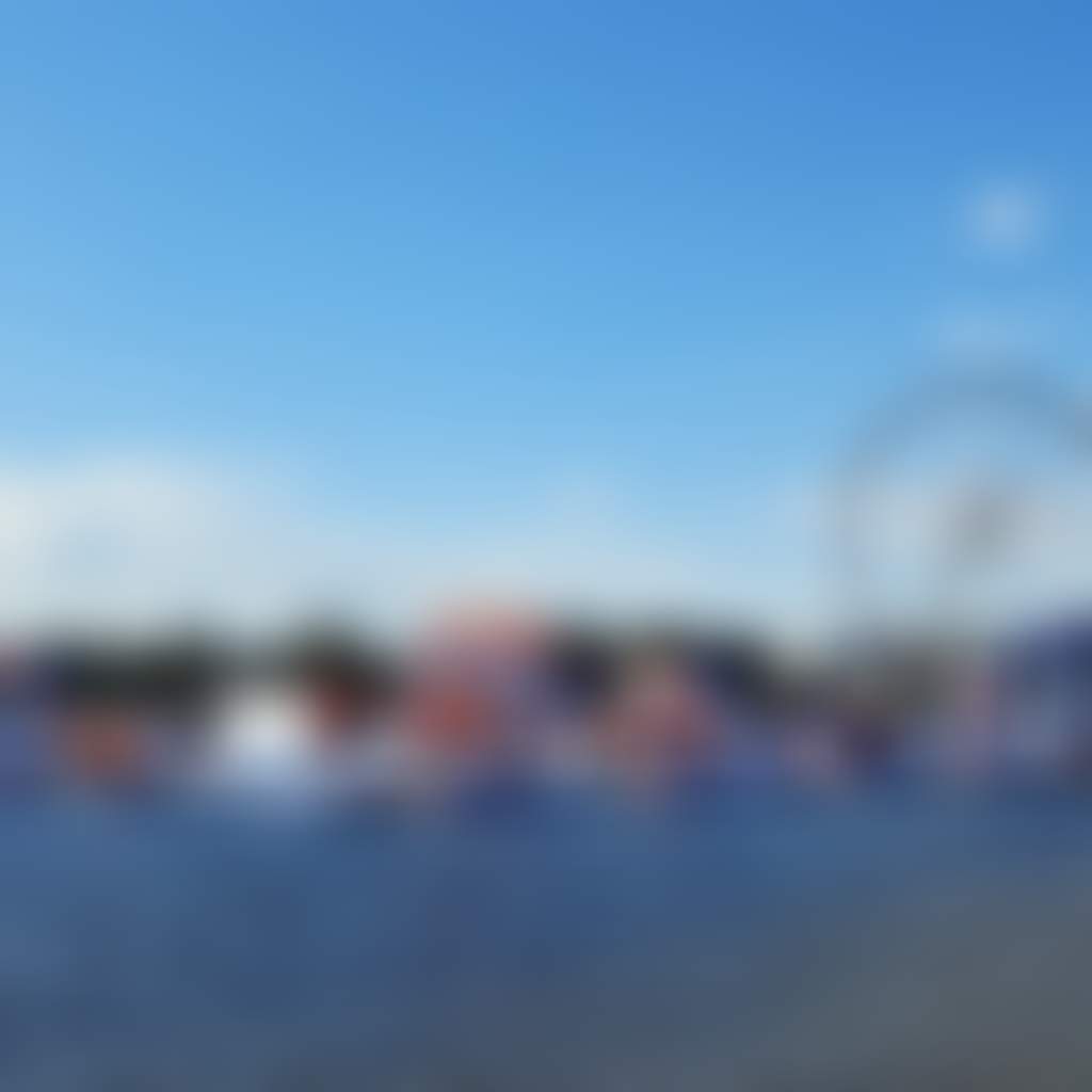 Lakes Entrance Aqua Park floating obstacle course on Cunninghame Arm infront of ferris wheel