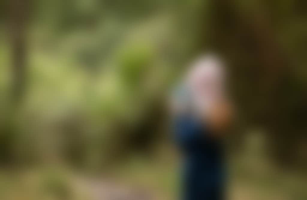 Morwell National Park girl surrounded by bush in beanie taking photo on camera