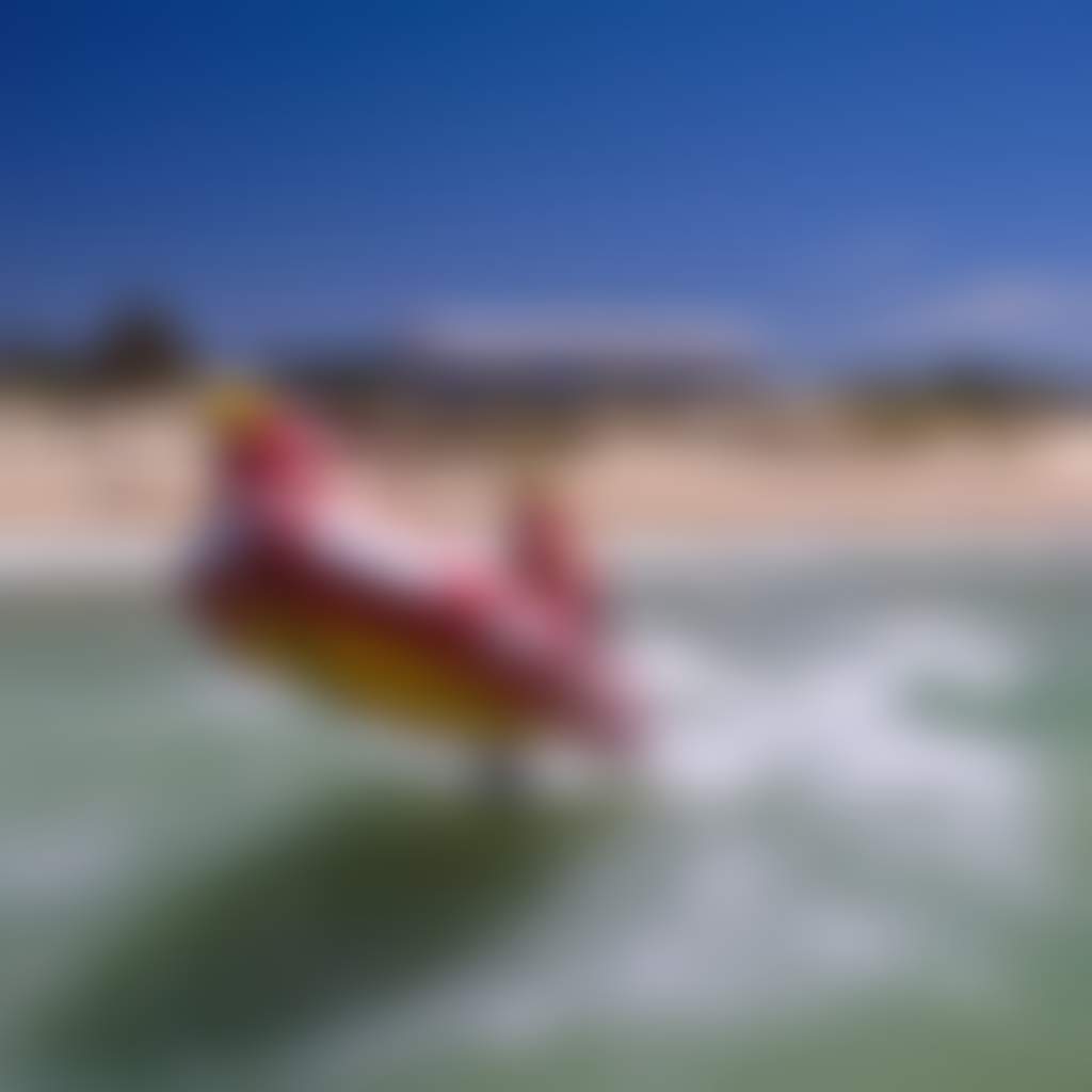 Seaspray Surf Lifesaving Club boat in surf on beach