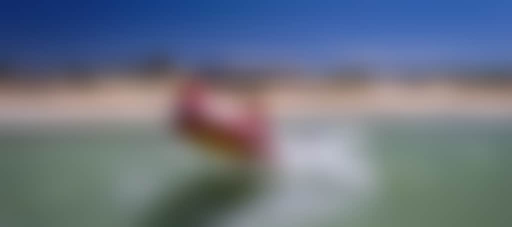 Seaspray Surf Lifesaving Club boat in surf on beach