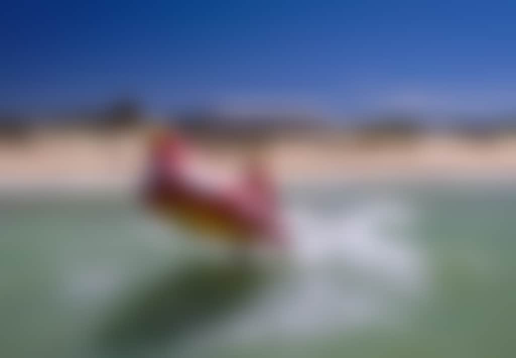 Seaspray Surf Lifesaving Club boat in surf on beach
