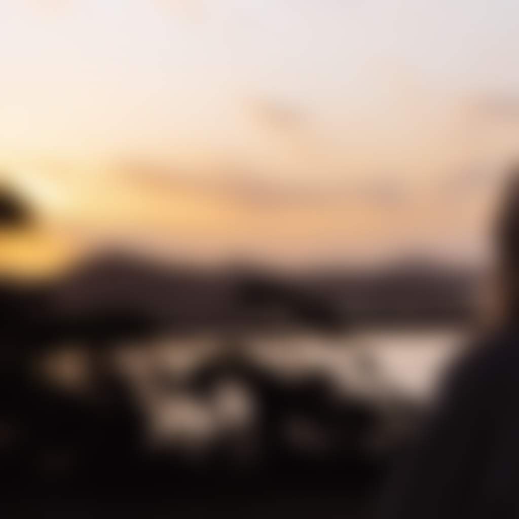 Marlo girl on balcony overlooking lake at sunset