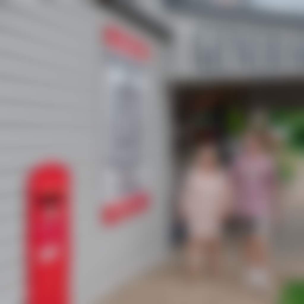 Couple walking outside general store post office in Buchan township