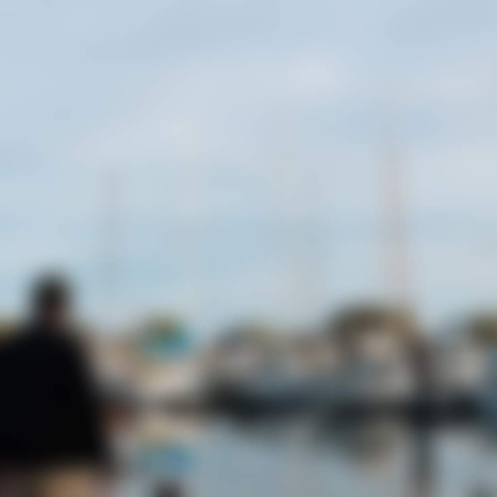 Loch Sport family looking at boats docked at jetty