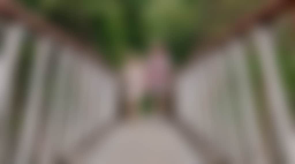 Couple walking on Buchan Swing Bridge over Buchan river