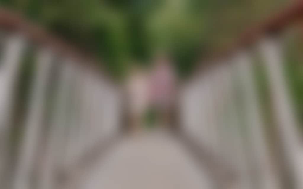 Couple walking on Buchan Swing Bridge over Buchan river