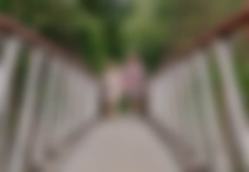 Couple walking on Buchan Swing Bridge over Buchan river