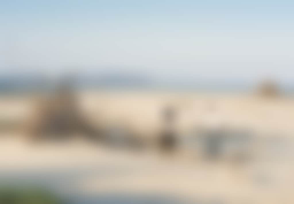 Inverloch Beach couple walking around driftwood sculpture