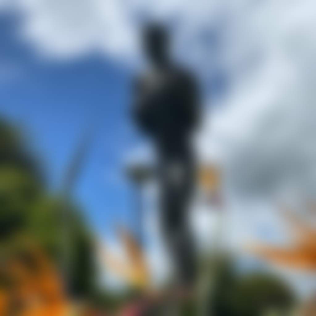 Lionel Rose Statue Warragul public art close up amongst bird of paradise flowers