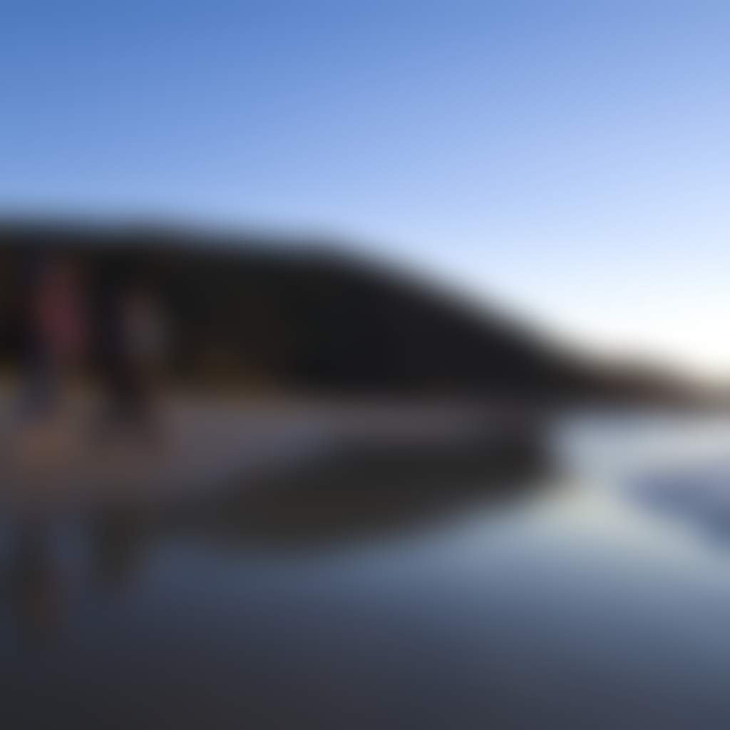 Two hikers walking on the beach