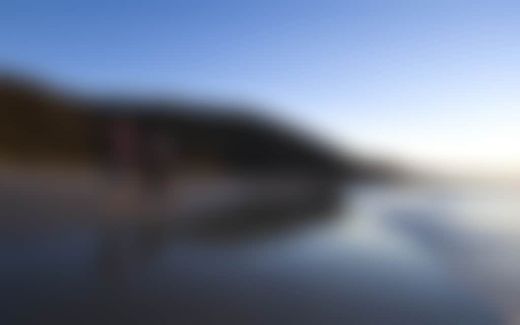 Two hikers walking on the beach