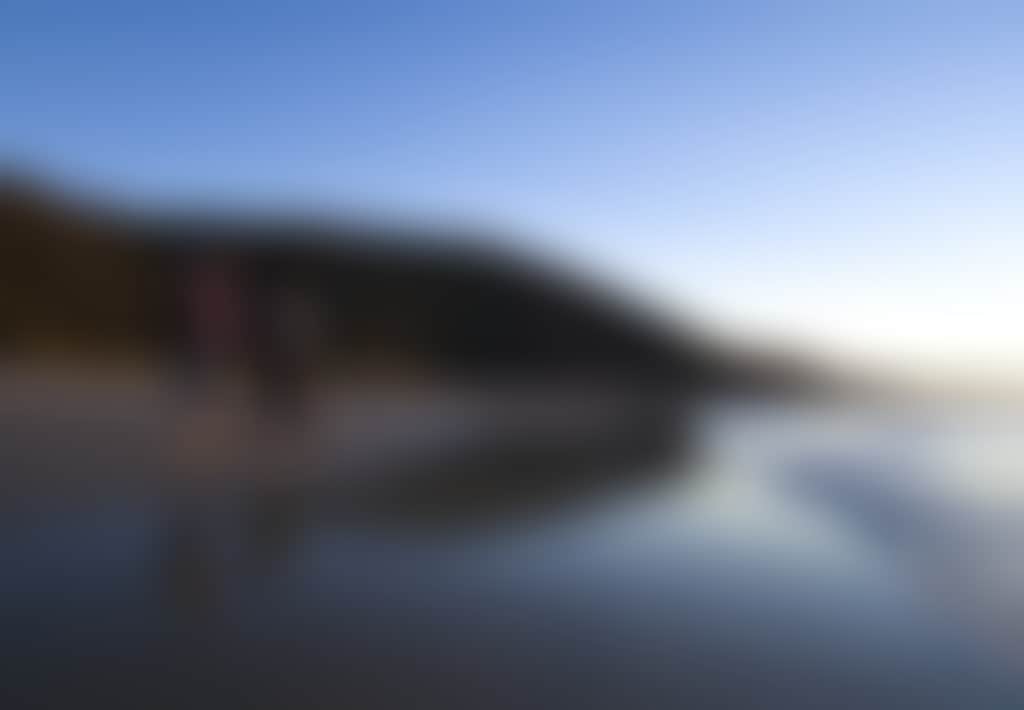 Two hikers walking on the beach