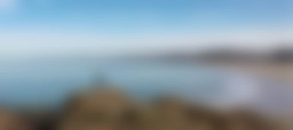 Cape Conran lady standing on rocks over beach