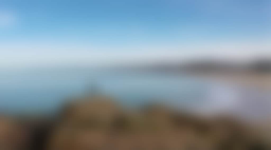 Cape Conran lady standing on rocks over beach