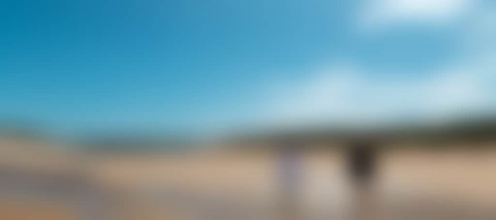 Powlett River couple walking along beach low tide