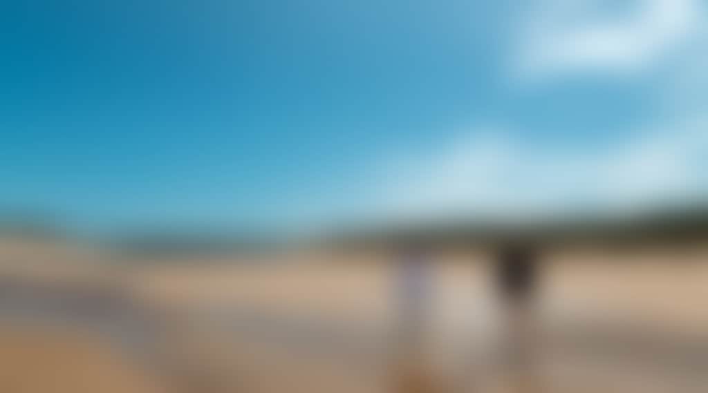 Powlett River couple walking along beach low tide