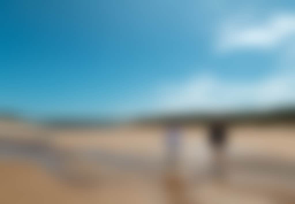 Powlett River couple walking along beach low tide