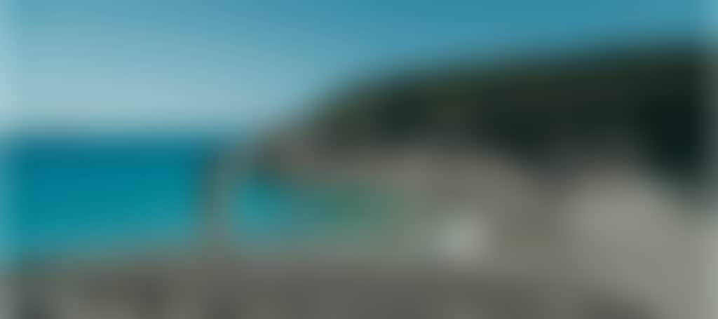 Squeaky Beach Wilsons Prom woman standing on rocks in front of turquoise water