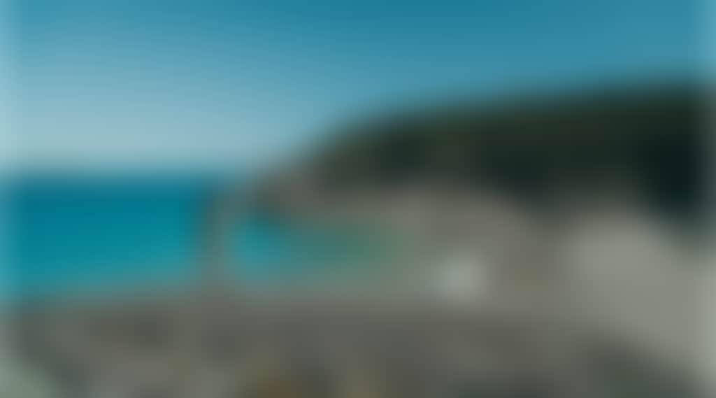Squeaky Beach Wilsons Prom woman standing on rocks in front of turquoise water