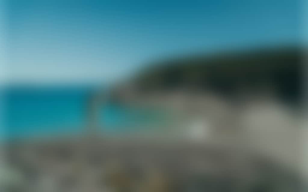 Squeaky Beach Wilsons Prom woman standing on rocks in front of turquoise water